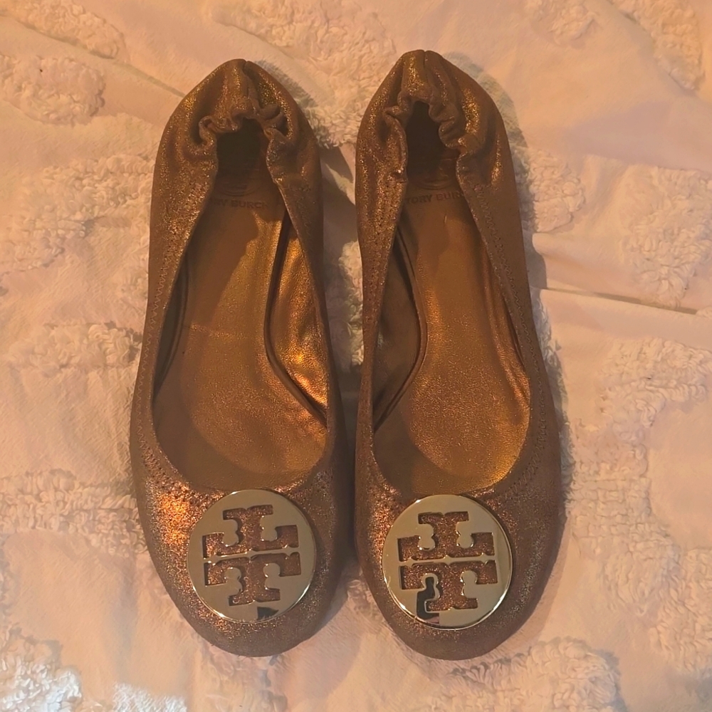 Tory Burch ballet flats, bronze with gold metal logo on front.